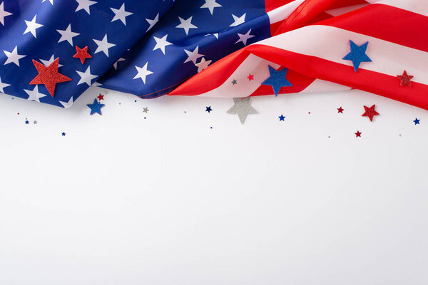 Festive mood of the public holiday: An evocative overhead composition displaying the American flag confetti stars on white backdrop. Ideal for advertisements or text placement during the occasion