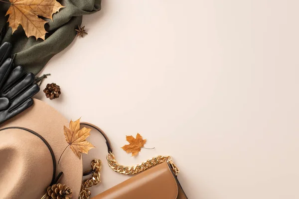 Trendy and warm clothes for fall season concept. Top view photo of brown handbag and felt hat, black gloves and scarf with maple leaves on white isolated background with copy-space for text or advert