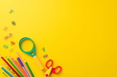 Malzeme konsepti. Yüksek açılı yaratıcı resim, sarı izole arkaplan üzerinde çeşitli çocuk eğitim gereksinimlerini yakalıyor, metin veya promosyon mesajları için kopyalama alanı