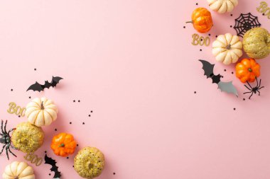 Çağdaş Cadılar Bayramı şaka mı şeker mi sahnesi. Tematik dekoru içeren en iyi görüntü: küçük parlak balkabakları, ürkütücü örümcekler, örümcek ağı, yarasalar ve soluk pembe fon üzerinde konfeti. Metin veya reklam için boşluk