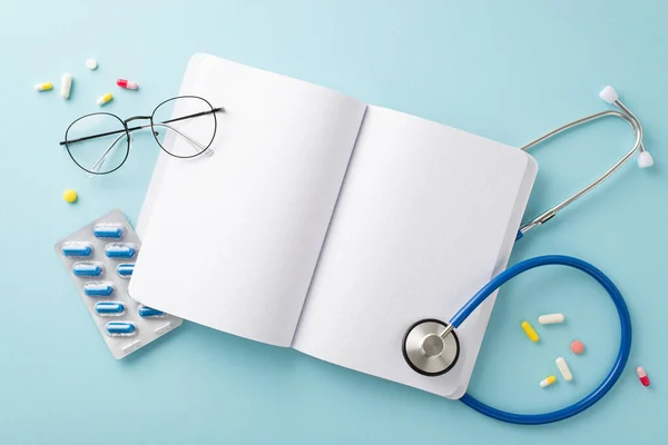 stock image Health Checkup Array: Stethoscope, open copybook, glasses, scattered pills arranged on a soothing blue background for your customizable text or ads