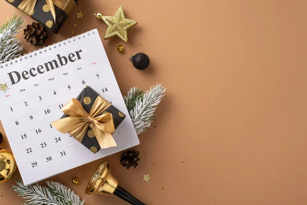 Counting down to New Beginnings: top-view of December calendar, lavish gift boxes, exquisite black and gold tree ornaments, sparkling confetti, bell, fir branches on terracotta backdrop, room for ad