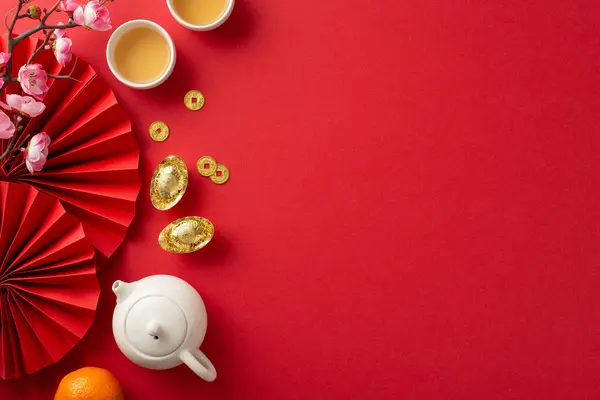 Celebrate Chinese New Year in grand style. Top view of vibrant red fans, tea ceremony set, lavish feast, iconic symbols like lucky coins. Embrace prosperity and good fortune with family and friends