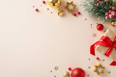 Her ayrıntıda yeni yılın zevki! Üst görünüm kağıt hediye kutusu, takılar, yıldız şekilli mumlar, ökseotu, şekerli köknar dalı, konfeti pastel bejde neşeli bir sahne, tatil metniniz için hazır.