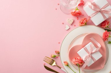 Anniversary Elegance: top view sophisticated table setting with heart-shaped plate, cutlery, wineglass, roses, gift boxes on pink background. Ideal ambiance for celebrating love. Text space available
