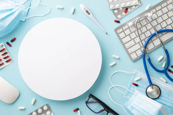 Virtual healthcare scene. Top view of PC peripherals, stethoscope, face masks, pills, thermometer, glasses on pastel blue backdrop with white circle, text space