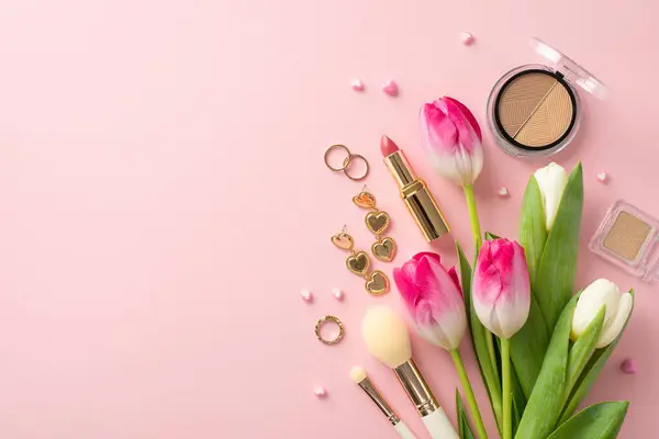 Sophistication in Bloom: Overhead composition with fresh tulips, eyeshadow, contouring palette, lipstick, cosmetic brushes, elegant jewelry, on pastel pink setting. Celebrate perfect lady with style