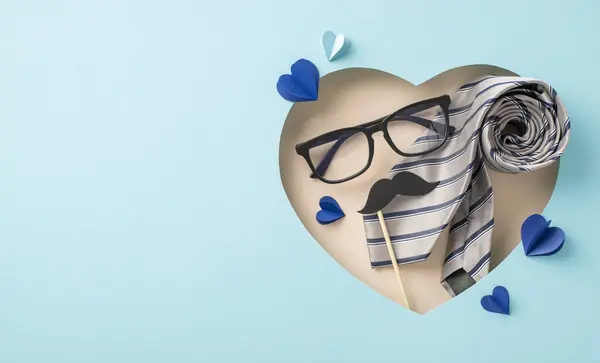 Send warm wishes on Father\'s Day with a sophisticated top view showcase of tie, mustaches, glasses, and more, set against a pastel blue backdrop. Heart-shaped cutout adds charm