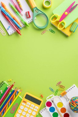 Assortment of colorful school supplies including pens, pencils, scissors, and calculators arranged on a vertical green background for back to school clipart