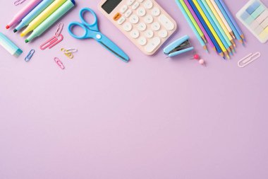 Okul malzemeleri arasında kalem, kalem, hesap makinesi, makas ve mor arkaplandaki ataçlar da var. Okul kavramlarına dönmek için ideal.