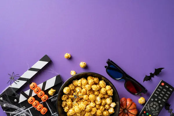 stock image A festive Halloween movie night scene featuring popcorn, 3D glasses, spooky decorations, and movie clapperboard