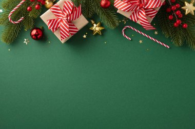 Noel süslemeleri, hediyeler, baston şekerler ve yeşil arka plandaki süsler, bayram atmosferi yaratıyor.