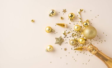 Altın Noel süsleri ve şampanya şişesi kutlama ve neşeli anları sembolize eder. Şenlik için mükemmel bir düzenleme. Şenlik ve şenlik ruhu.