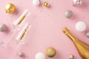 Yeni yılı şampanya bardakları ve pembe arka planda altın madalyalarla kutlayın. Şenlik için mükemmel.