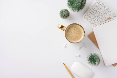 A top view of a winter-themed workspace featuring a coffee cup, keyboard, notebook, and decorative plants. Ideal for creative professionals and winter office inspiration clipart