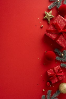 A vertical bright red holiday scene featuring gift boxes, ribbons, gold stars and ornaments with pine branches, perfect for festive Christmas and New Year greetings and celebrations