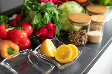 A table full of healthy vegetables, fruits and nuts, tomato, pepper, lemon