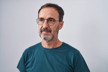 Middle age man standing with serious expression over isolated white background