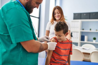 Family vaccinating child having medical consultation at clinic