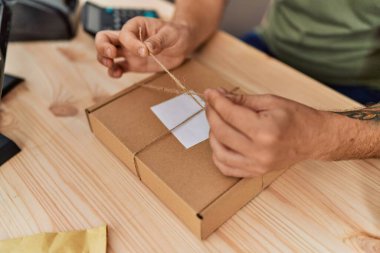 Young redhead man business worker prepare order package at office