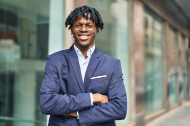 African american man executive smiling confident standing with arms crossed gesture at street