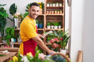 Çiçekçide elinde çiçek saklayan İspanyol bir çiçekçi.