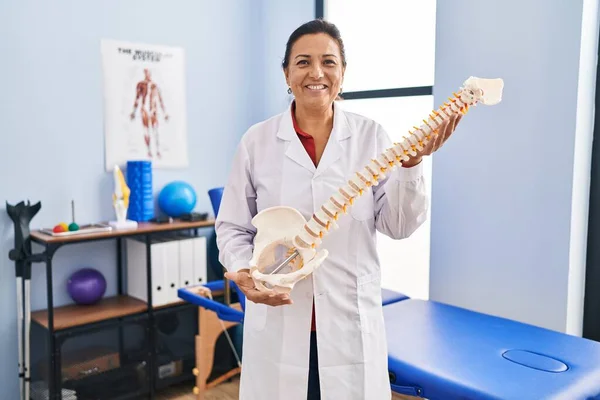 Middle Age Hispanic Woman Holding Anatomical Model Spinal Column Smiling — Foto de Stock