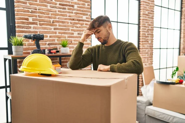 Young Arab Man Stressed Leaning Package New Home —  Fotos de Stock