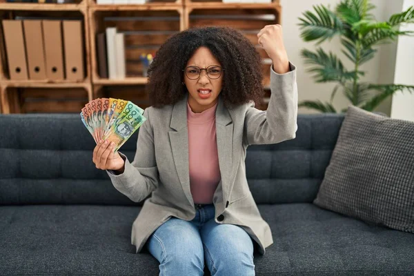 Young African American Woman Holding Australian Dollars Consultation Office Annoyed — Stockfoto