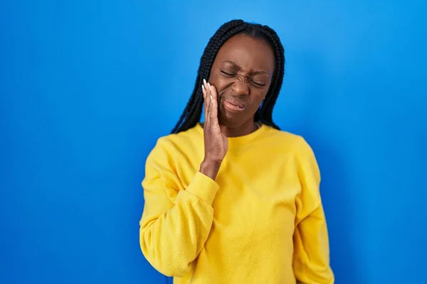 Beautiful Black Woman Standing Blue Background Touching Mouth Hand Painful — Foto de Stock
