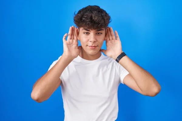 Hispanic Teenager Standing Blue Background Trying Hear Both Hands Ear — Stock Photo, Image