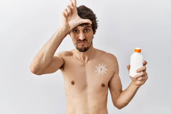Young Hispanic Man Standing Shirtless Holding Sunscreen Lotion Making Fun — Stock Photo, Image