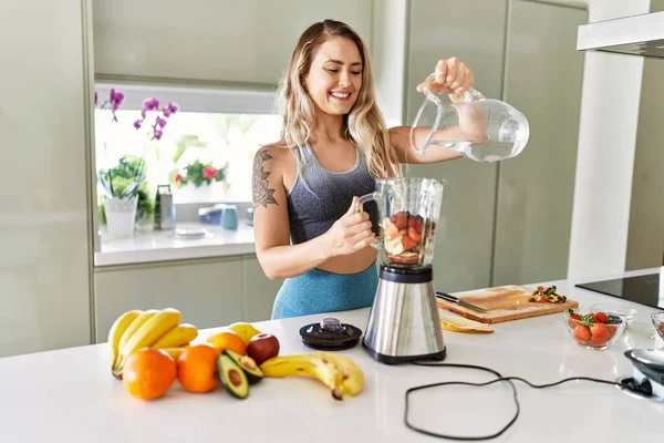 Young Woman Smiling Confident Pouring Water Blender Kitchen — Stok fotoğraf