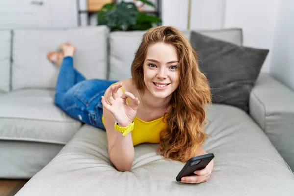 Young Caucasian Woman Lying Sofa Using Smartphone Smiling Positive Doing — Foto de Stock