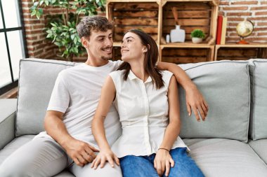 Man and woman couple smiling confident hugging each other at home
