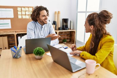 Man and woman business workers smiling confident working at office