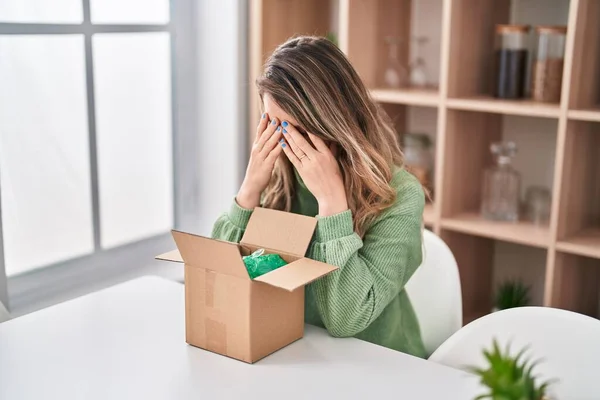 Young Woman Unboxing Package Worried Expression Home — Stock Photo, Image