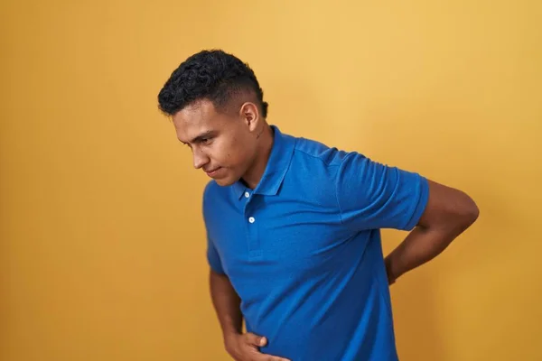 Young Hispanic Man Standing Yellow Background Suffering Backache Touching Back — Stock Photo, Image