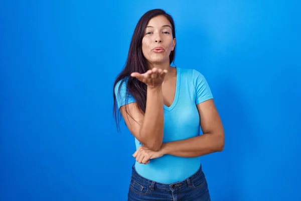 Young Hispanic Woman Standing Blue Background Looking Camera Blowing Kiss — Fotografie, imagine de stoc