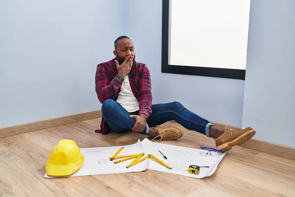 African American Man Sitting Floor New Home Looking Blueprints Bored — Stock Photo, Image