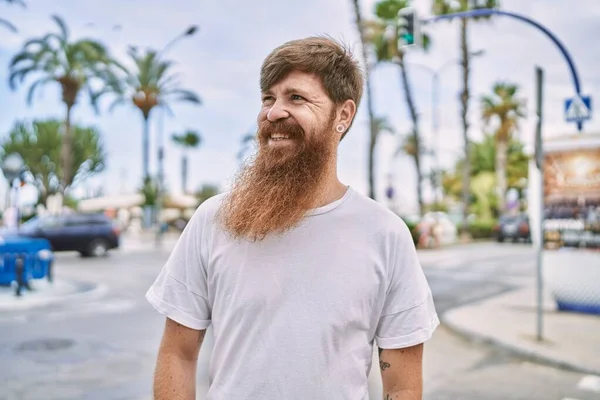 stock image Young redhead man smiling happy standing at the city.