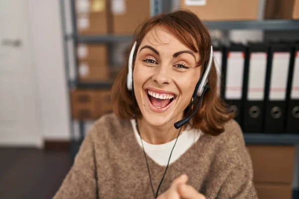 Young caucasian woman call center agent speaking at office