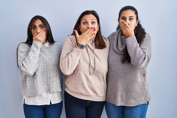 Mother Two Daughters Standing Blue Background Shocked Covering Mouth Hands — Stock Photo, Image