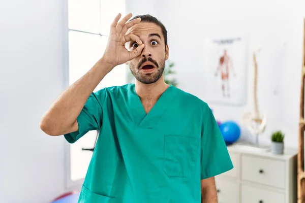 Young Physiotherapist Working Pain Recovery Clinic Doing Gesture Shocked Surprised — Stok fotoğraf