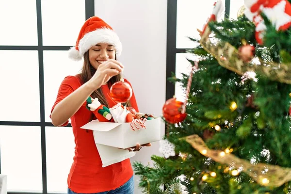 Young Latin Woman Open Gift Bag Sitting Christmas Decor Home — Φωτογραφία Αρχείου