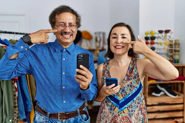 Středním Věku Mezirasový Pár Maloobchodě Pomocí Smartphonu Ukazuje Prstem Tvář — Stock fotografie
