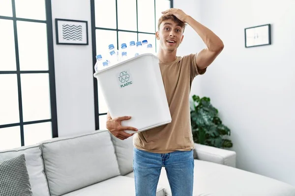 Young Caucasian Man Holding Wastebasket Recycling Plastic Bottles Home Stressed — Stock Photo, Image