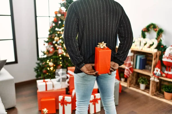Young African American Man Holding Gift His Back Standing Christmas —  Fotos de Stock