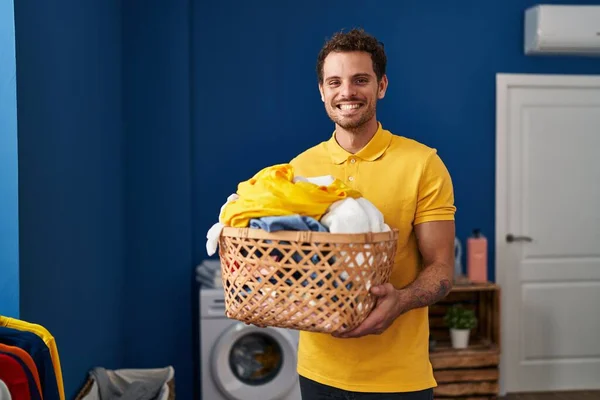 Young Hispanic Man Holding Laundry Basket Smiling Happy Cool Smile — Zdjęcie stockowe