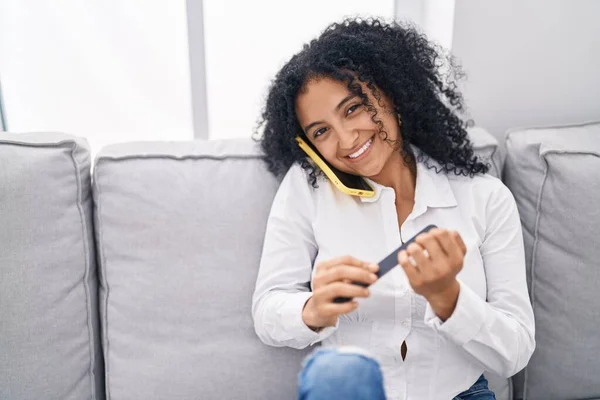 Young Hispanic Woman Talking Smartphone Make Manicure Home —  Fotos de Stock